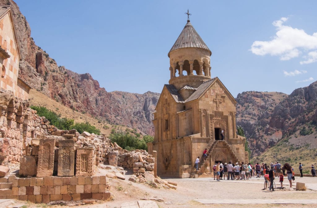Noravank Monastery, a small sand-covered church surrounded by mountains.