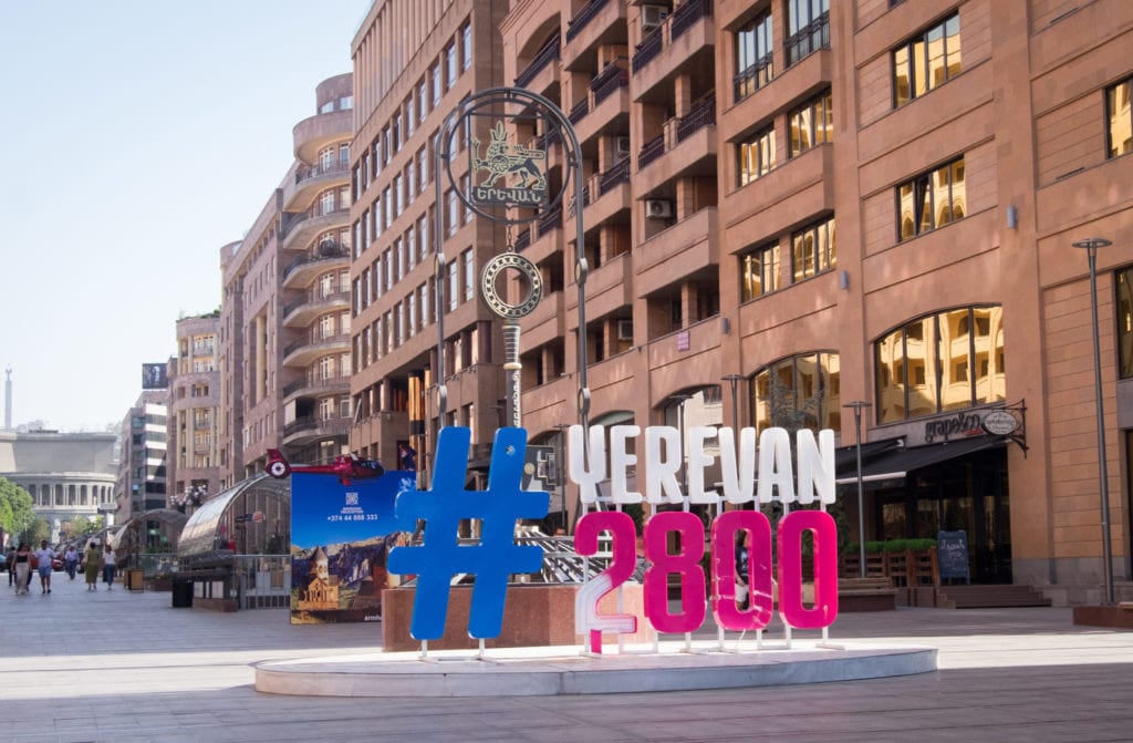 A pedestrian-only street with a large sign reading #Yerevan2800.