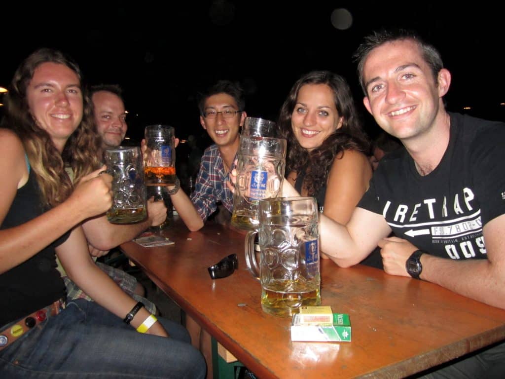 Friends enjoying liter beers at a beer garden in Munich.