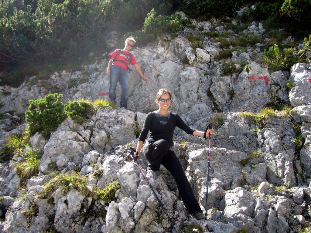 Kate hiking down a very rocky pass with hiking poles.