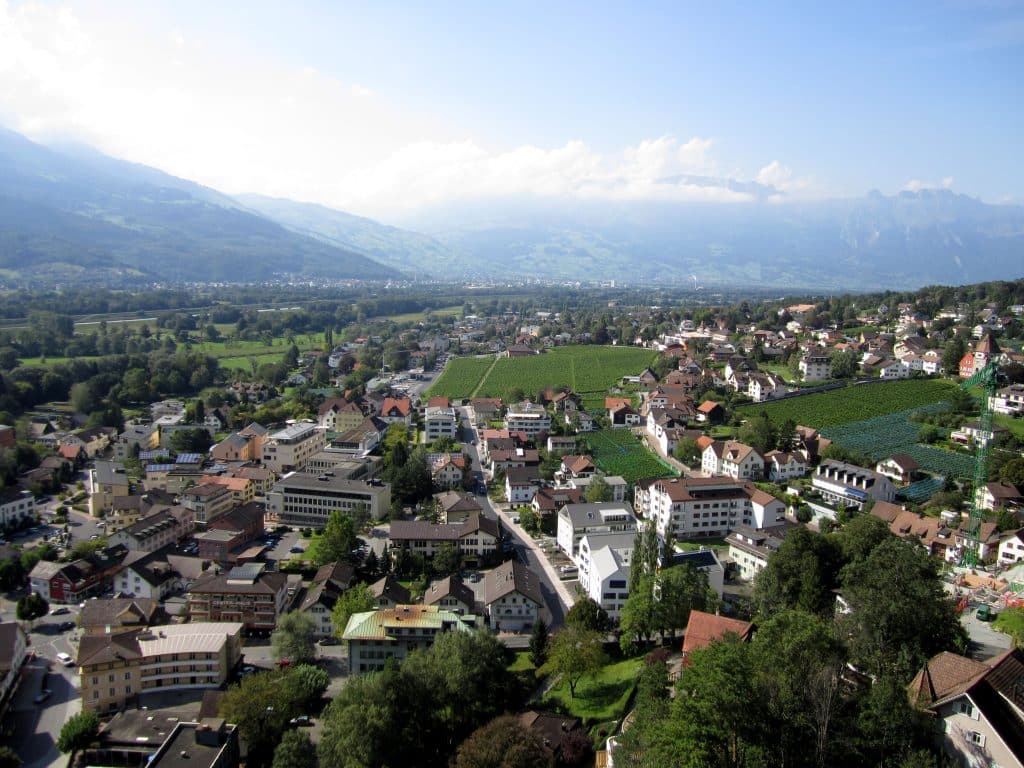 The view over a valley in the alps, filled with small houses.