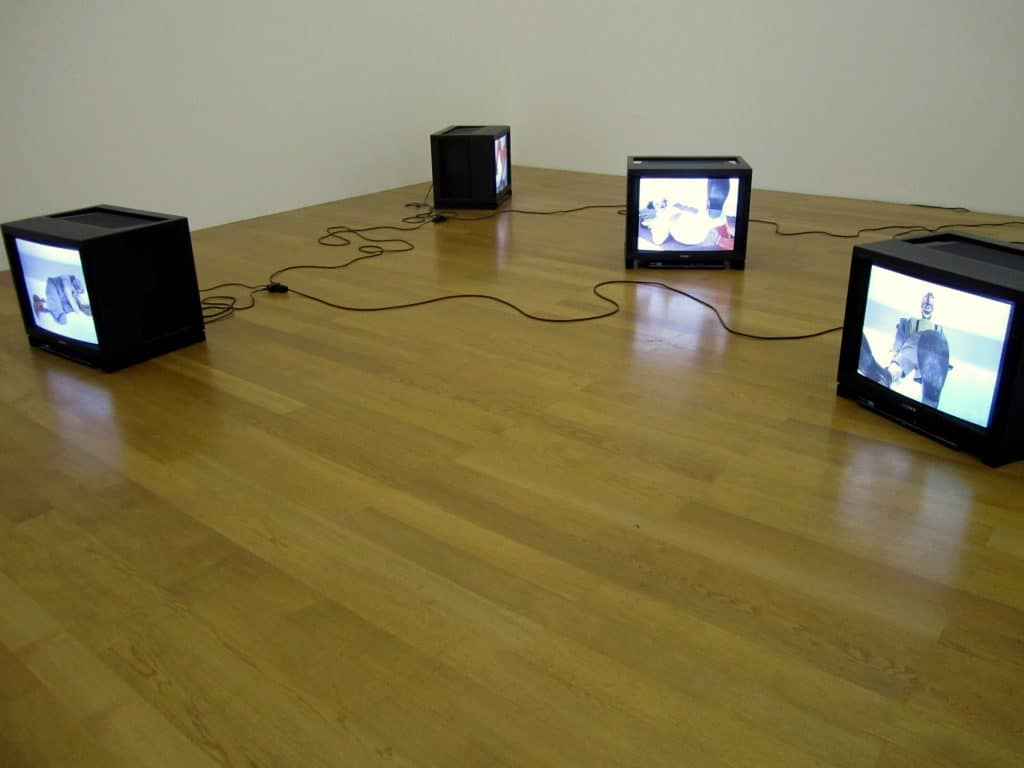 An art installation of four old TVs on the ground