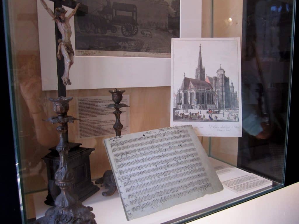 Mozart's handwritten music in a museum case.