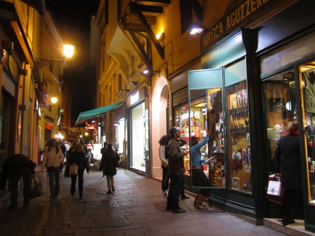 People walking the streets of Bologna at night