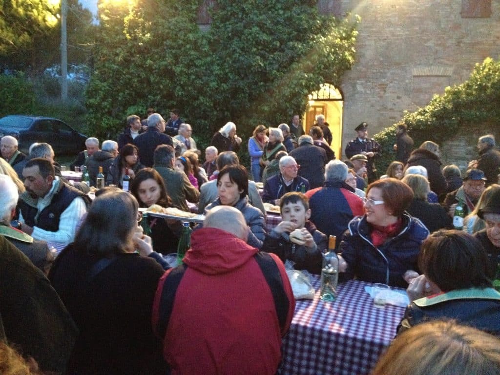 People sitting outdoors and eating food in 'Italy.