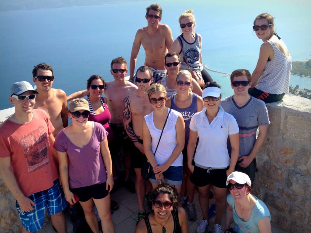 A group of friends standing at a lookout in Croatia with the ocean behind them.