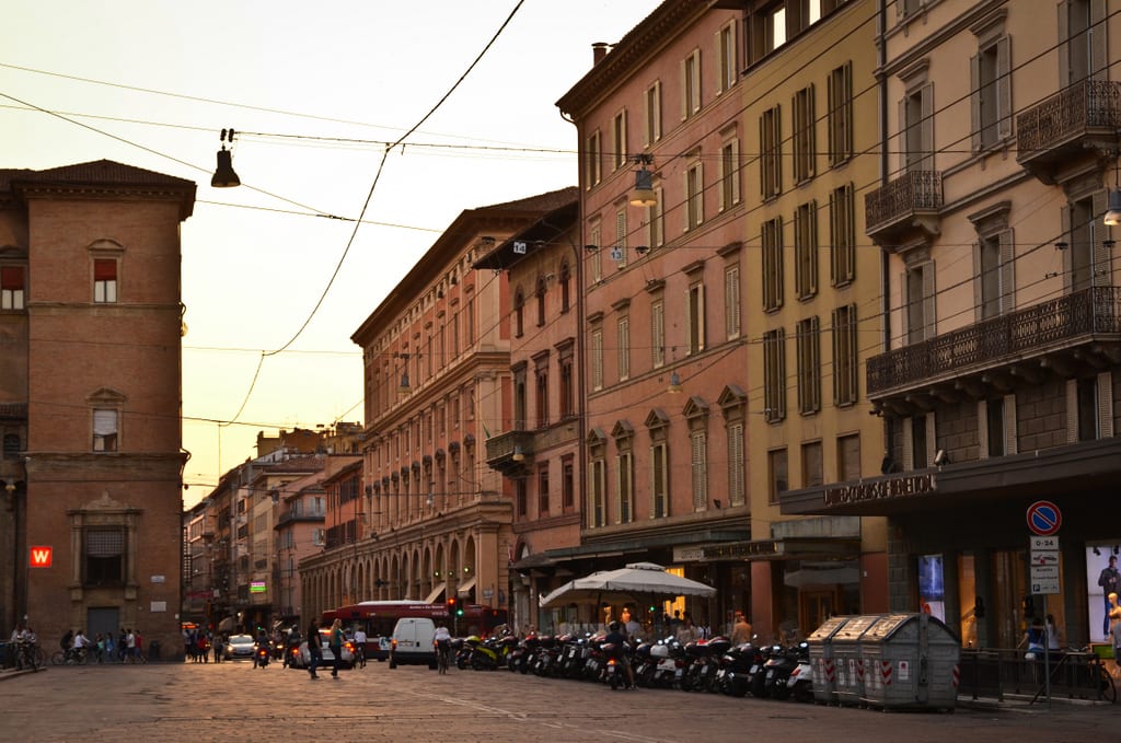 The red city walls of Bologna, as the sun begins to set.