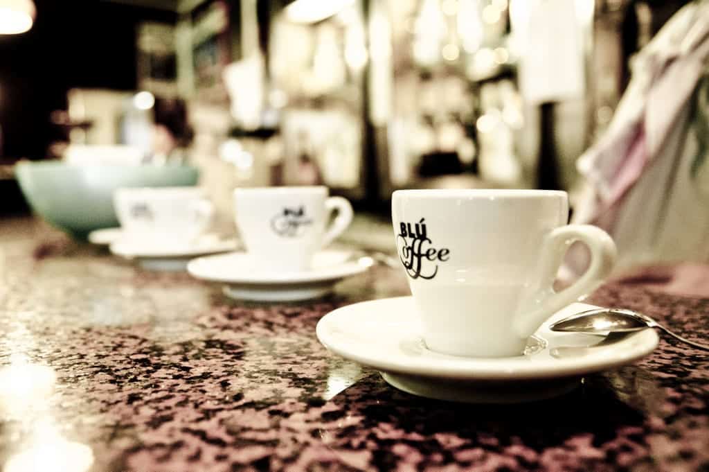 Rows of espresso cups on a counter in an Italian cafe.