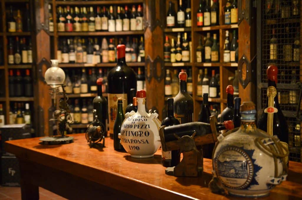 Big jugs of wine on a table in a wine cellar.
