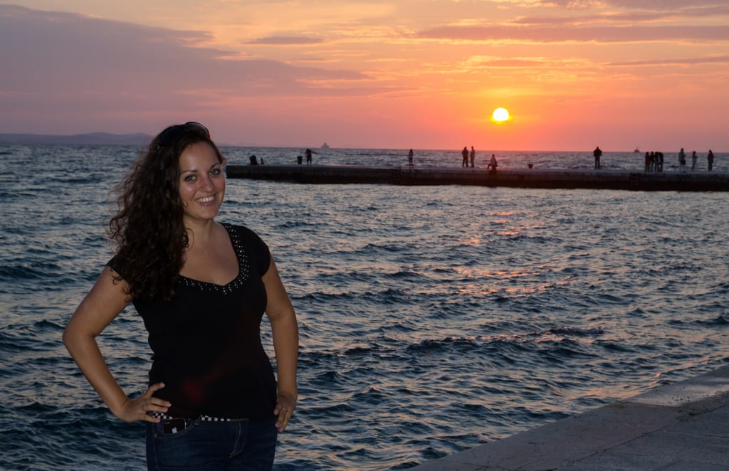 Kate poses in front of a sunset in Zadar, Croatia.