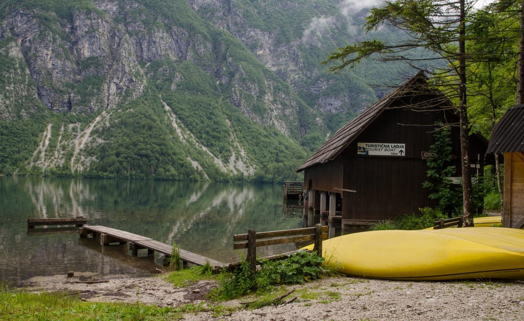 A yellow kayak and cabin in Lake Bohinj Slovenia