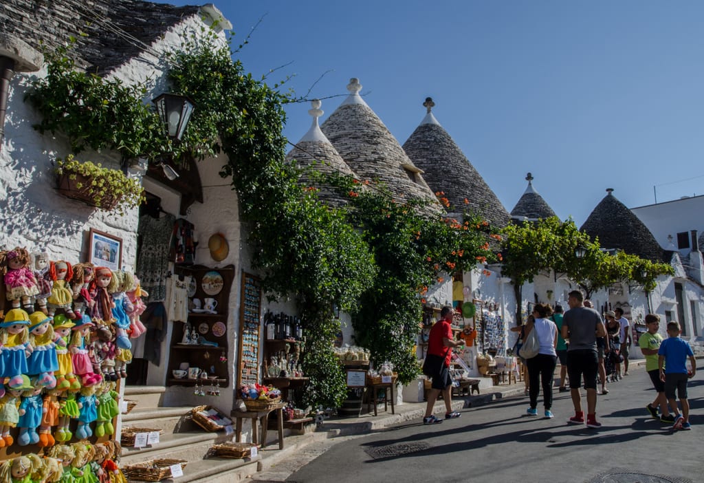 The town of Alberobello, filled with white conical homes topped with gray shale roofs.