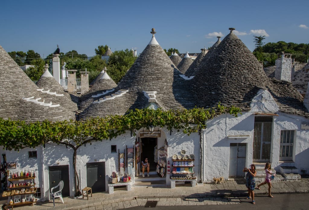 Conical white and gray "trulli" homes with a pointy roof.