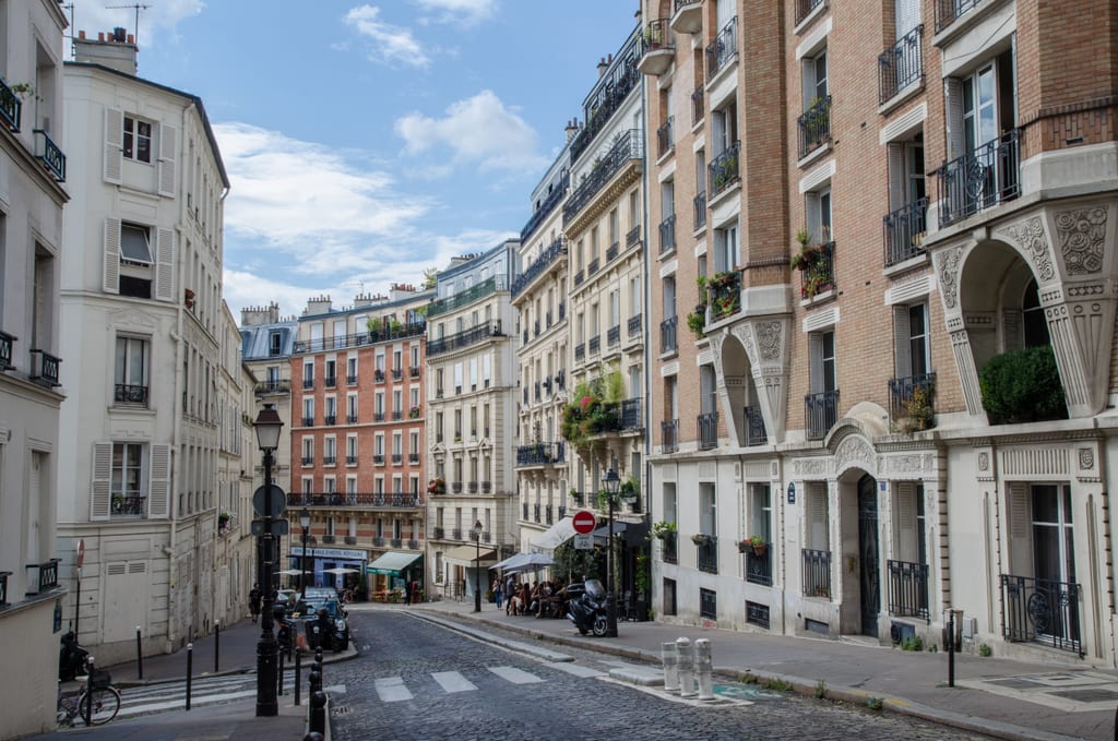 Curving, hilly streets of Montmartre filled with wrought-iron balconies.