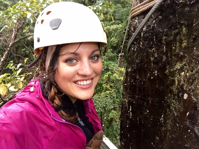 Kate wearing a helmet and pink jacket while zip lining in Monteverde, Costa Rica