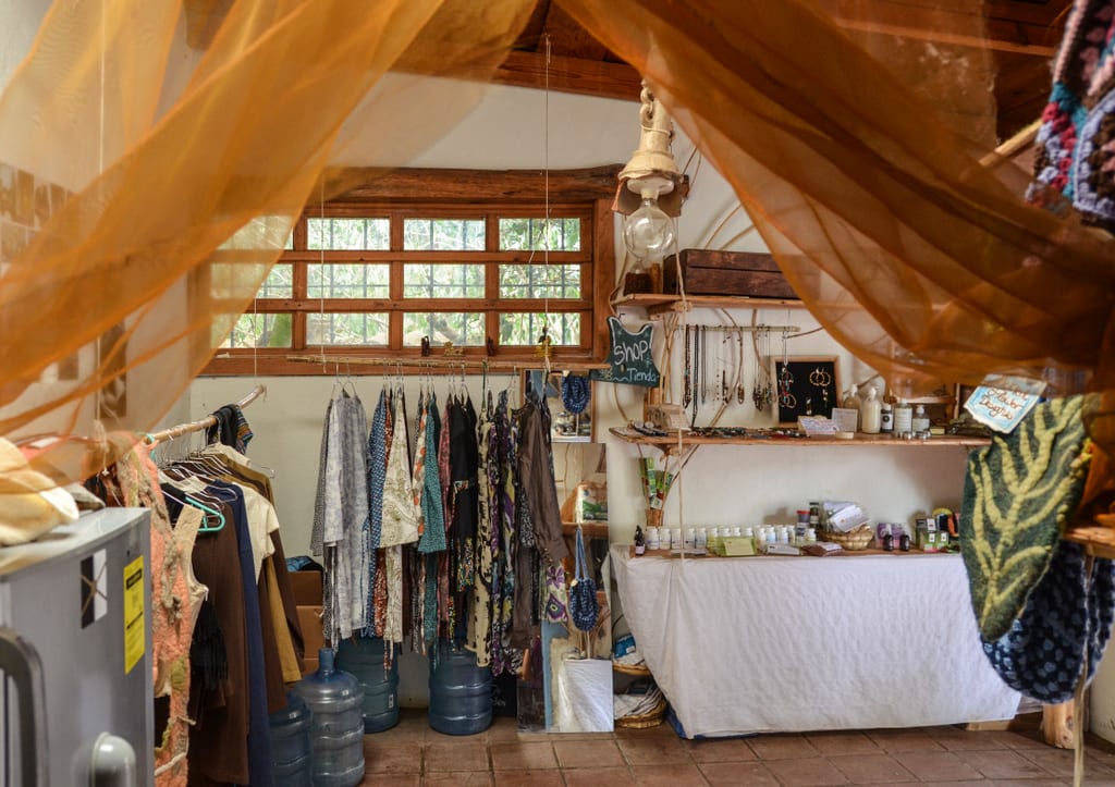 A boutique filled with brightly colored hippie shirts, jewelry and toiletries.