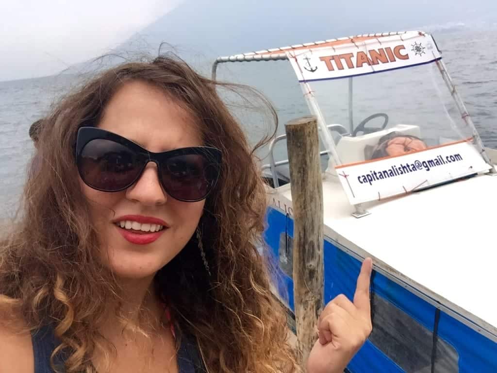 famous short stories about travel Kate stands in front of a small boat on Lake Atitlan named "Titanic." Kate points to it with an incredulous expression on her face.