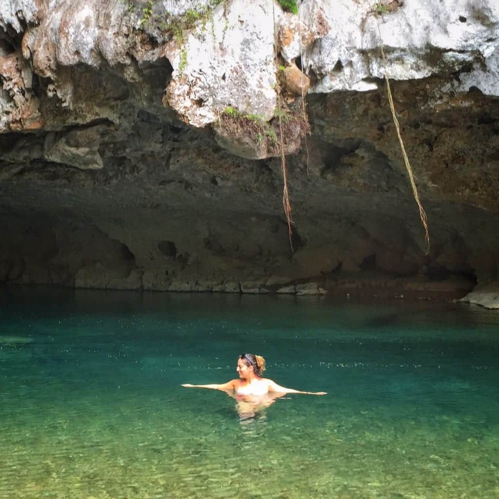 Kate floats in a cave in Belize