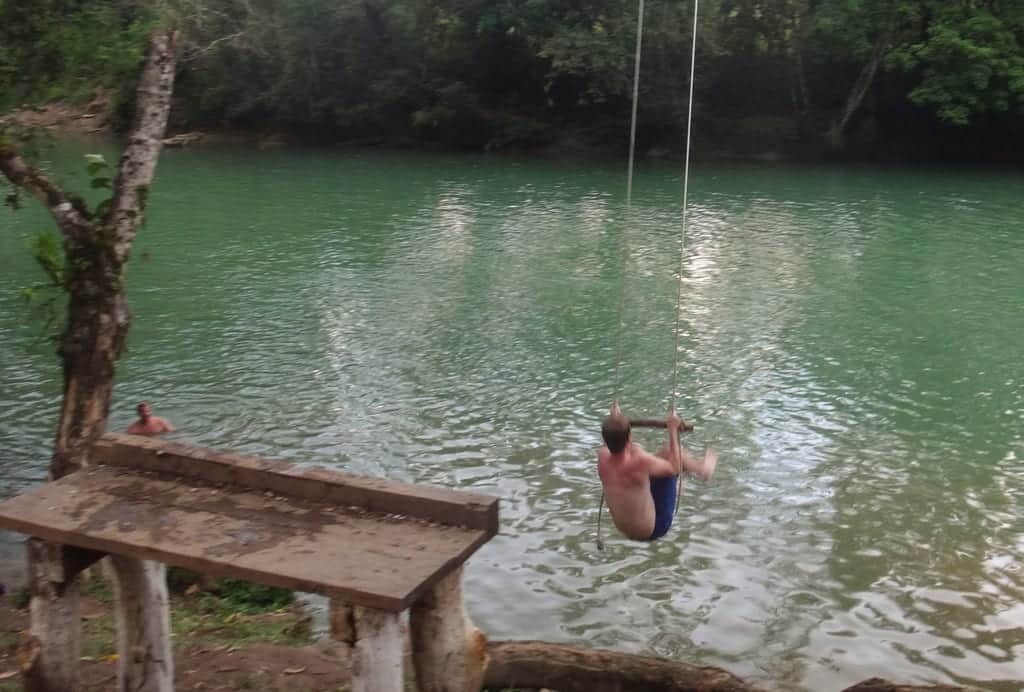 Shaun at Semuc Champey swinging out on a rope swing into the river.