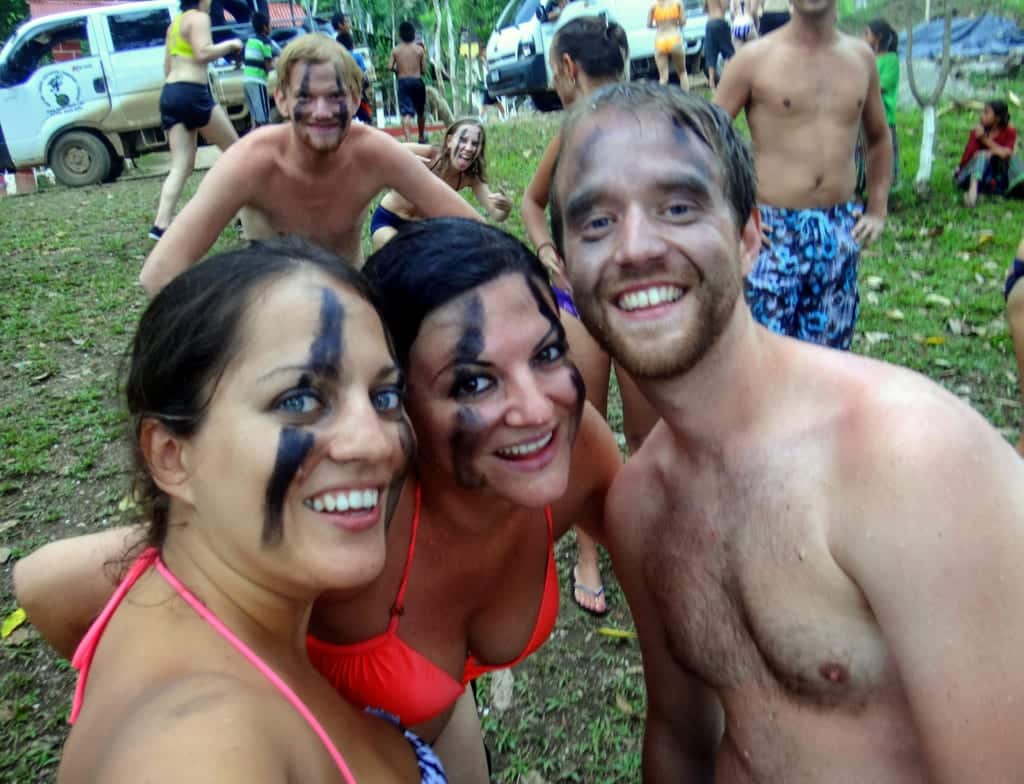 Kate, Erisa and Shaun taking a smiling selfie. Behind them a Swedish couple photobomb with goofy faces.