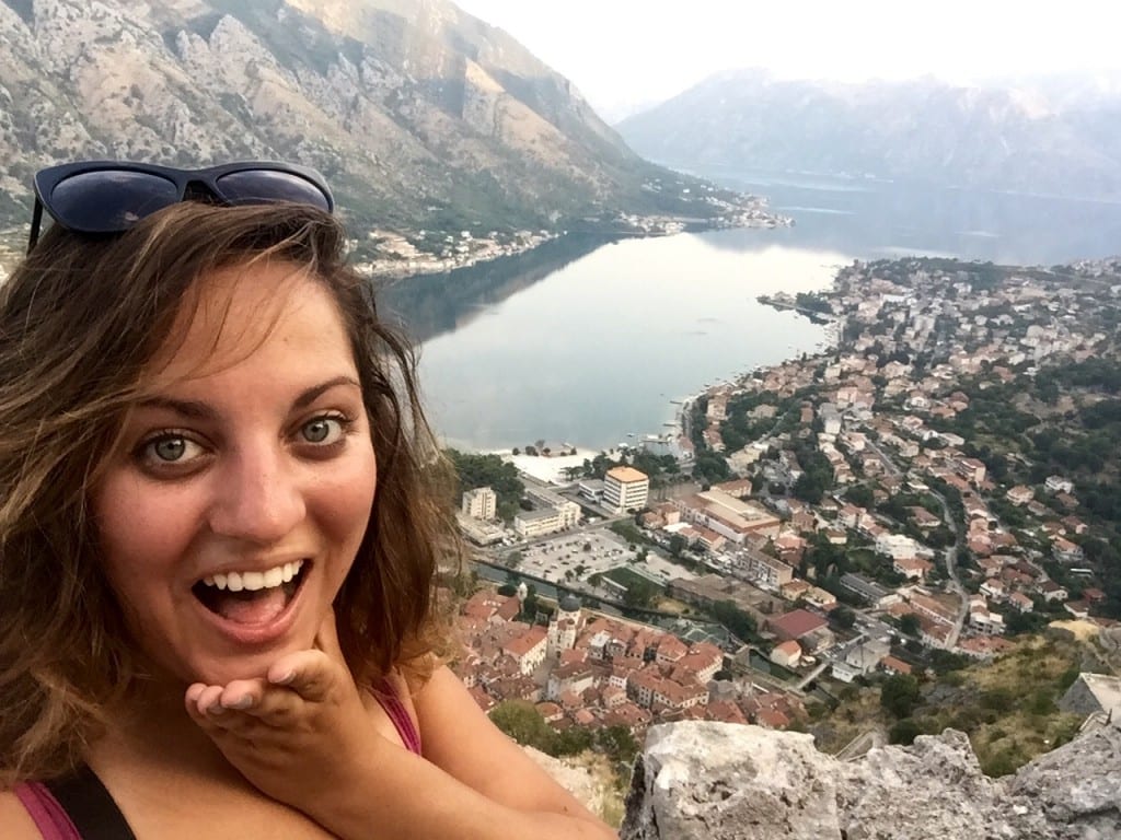 Kate takes a selfie at sunrise in front of the Bay of Kotor