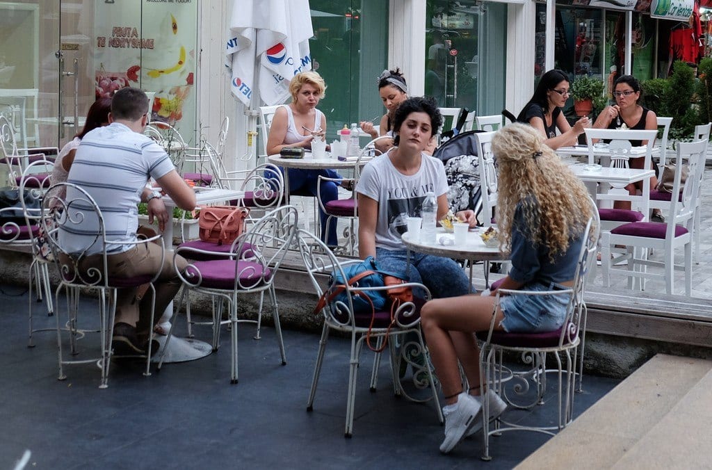 A bunch of young women sitting at an outdoor cafe in Tirana.