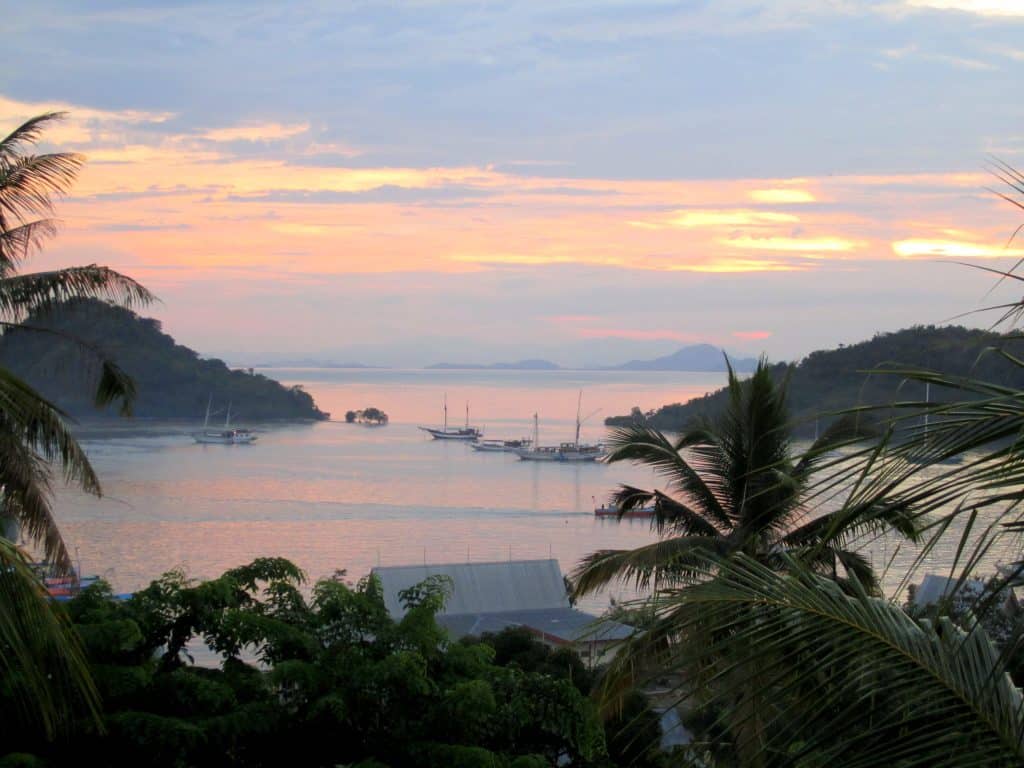A pink and purple sunset on a tropical island in Indonesia 