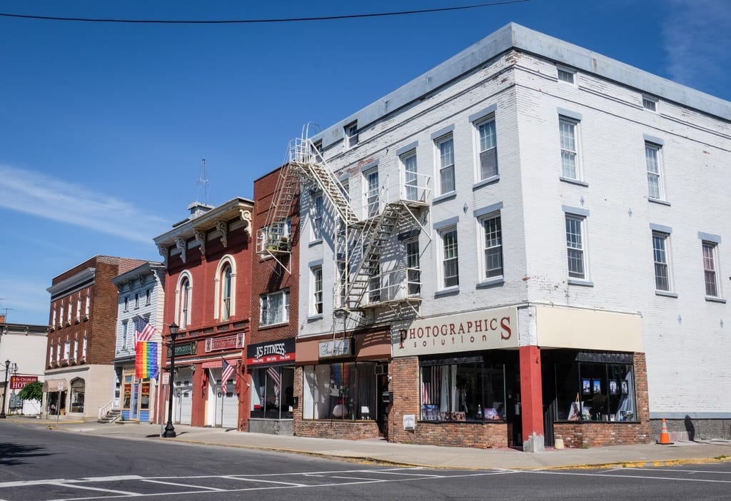 Warren street and its shops and boutiques, a few pride flags hanging.