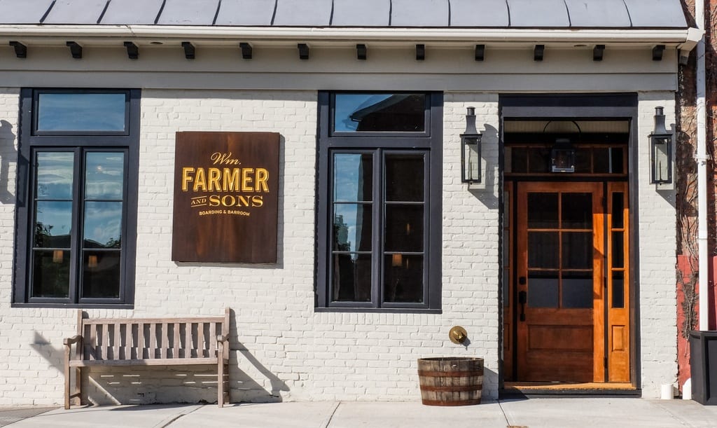 A white brick building with a sign reading Wm Farmer and Sons.