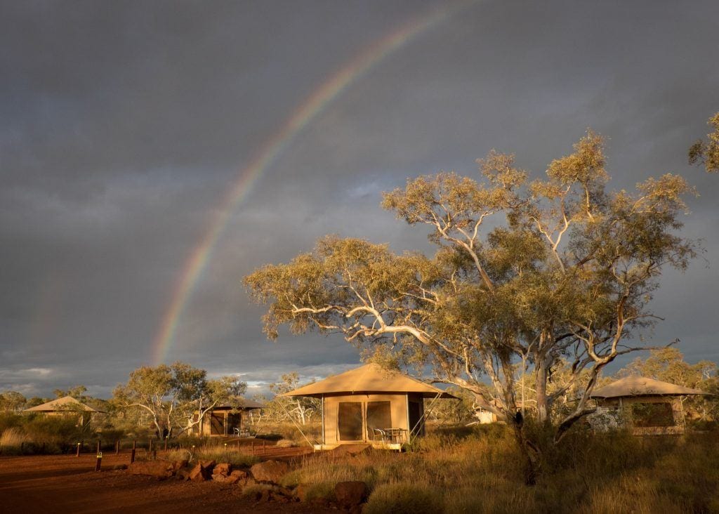 A rainbow over a tent in Karijini National Park, Australia