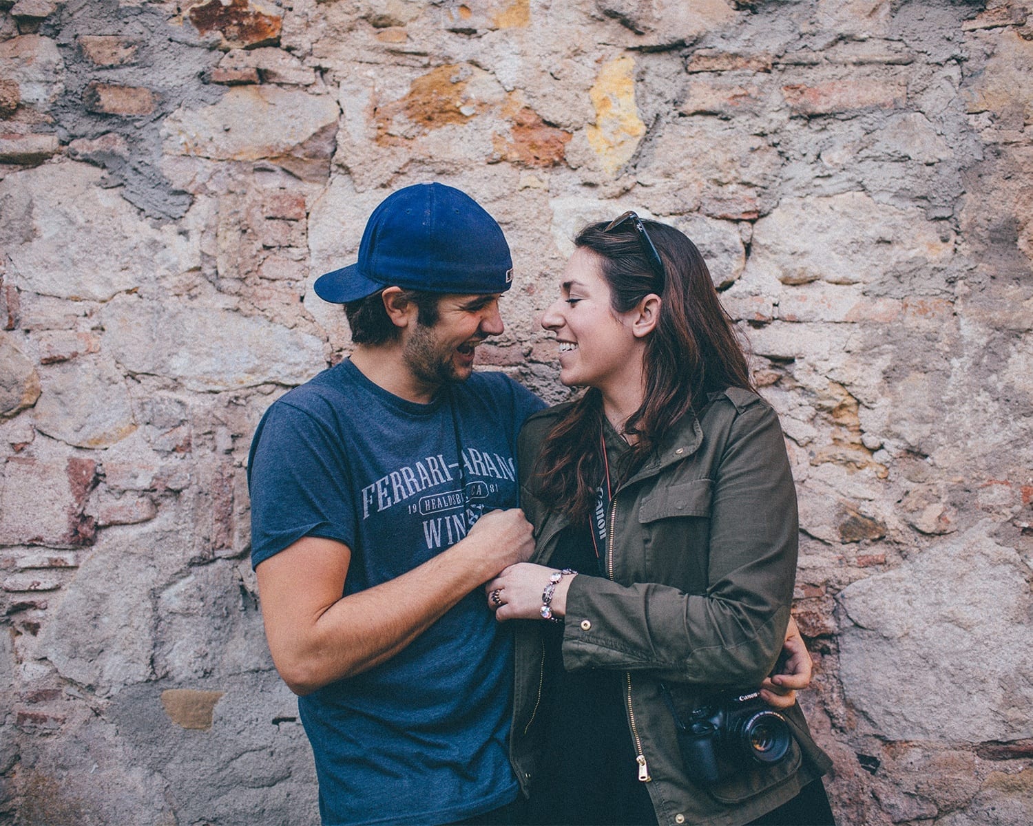 Ashley and Alex of In Pursuit of Adventure, smiling with their arms around each other.