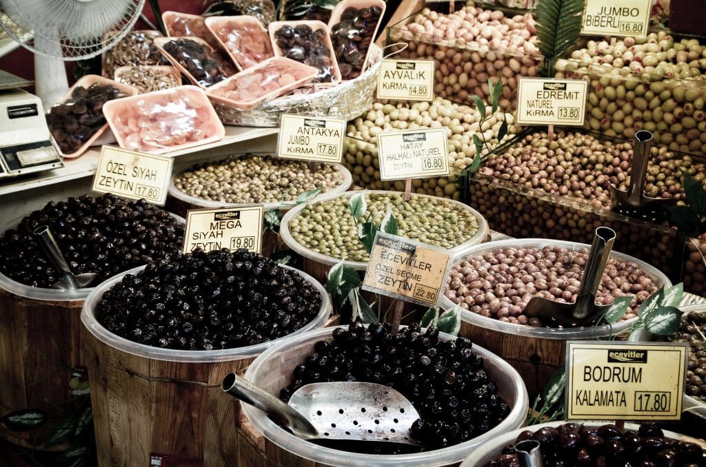 Barrels full of multicolored olives in a market