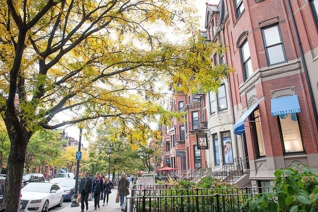 Brownstones and a sidewalk with trees with yellow leaves, Back Bay, Boston.