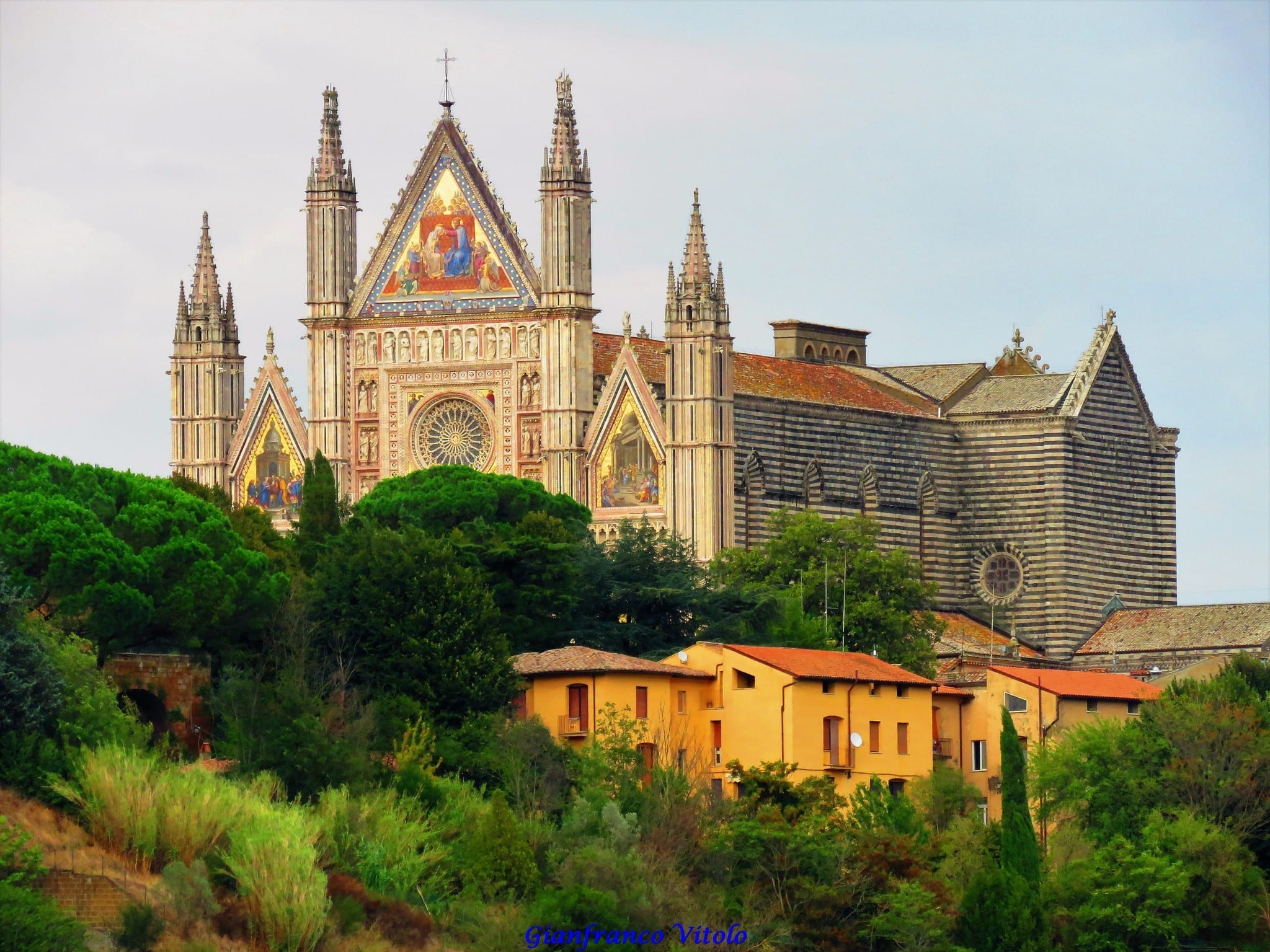 Partial front view of the Duomo di Orvieto with brightly painted scenes