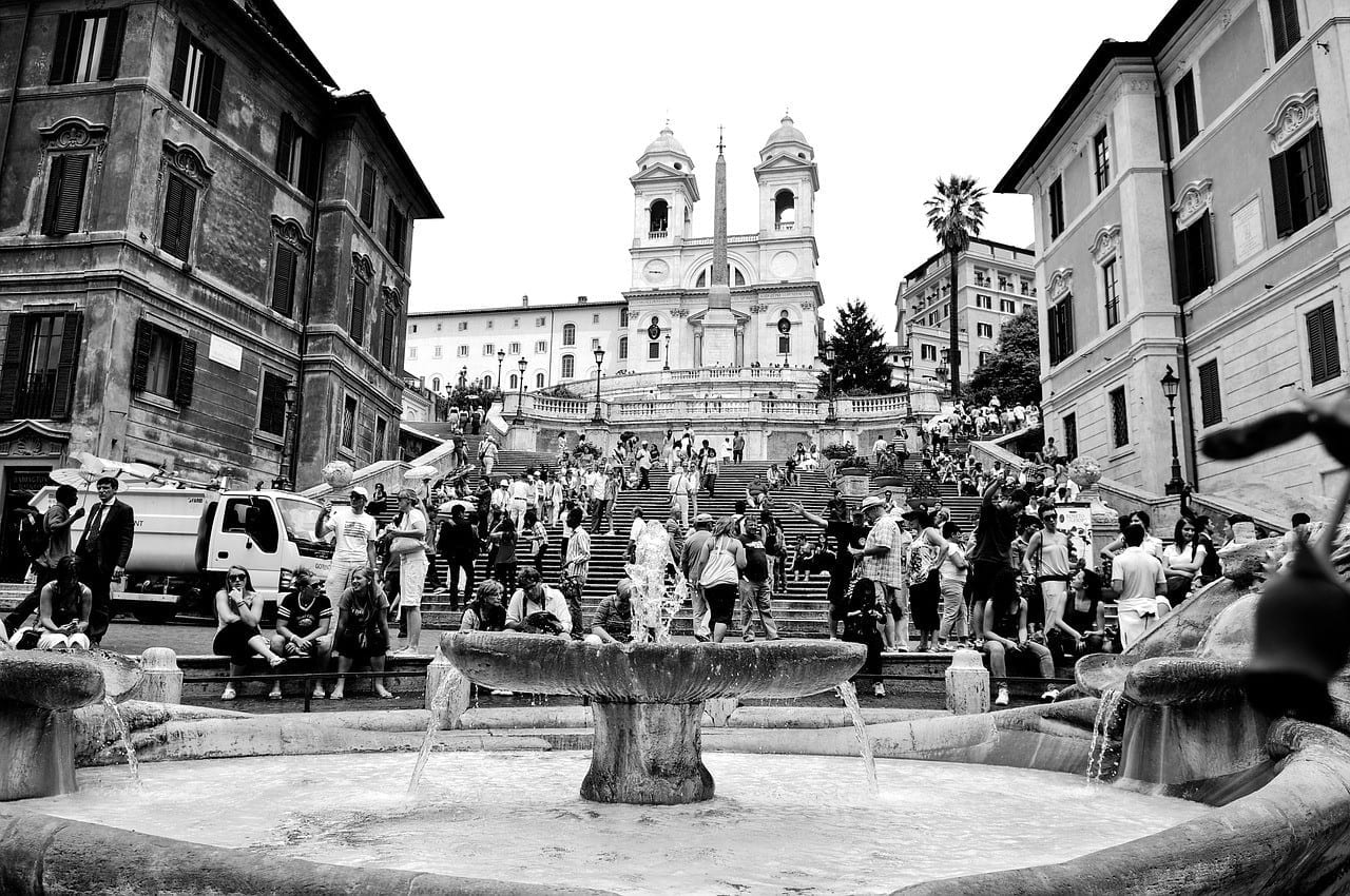 Crowds of people climbing up the Spanish Steps in Rome.