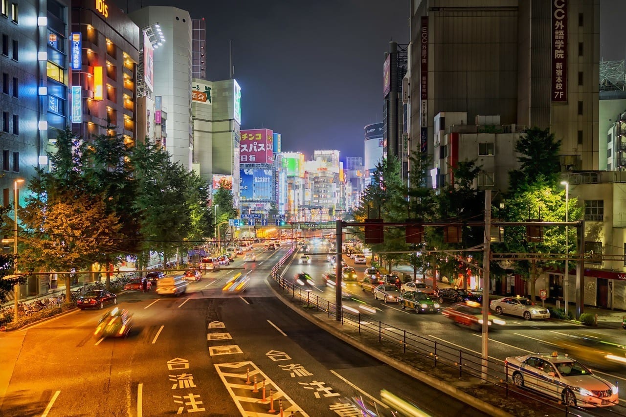 A Tokyo scene from above -- busy streets and neon skyscrapers.