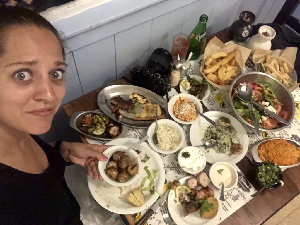 Kate has a worried expression in front of a giant table filled with around 15 dishes of food for her