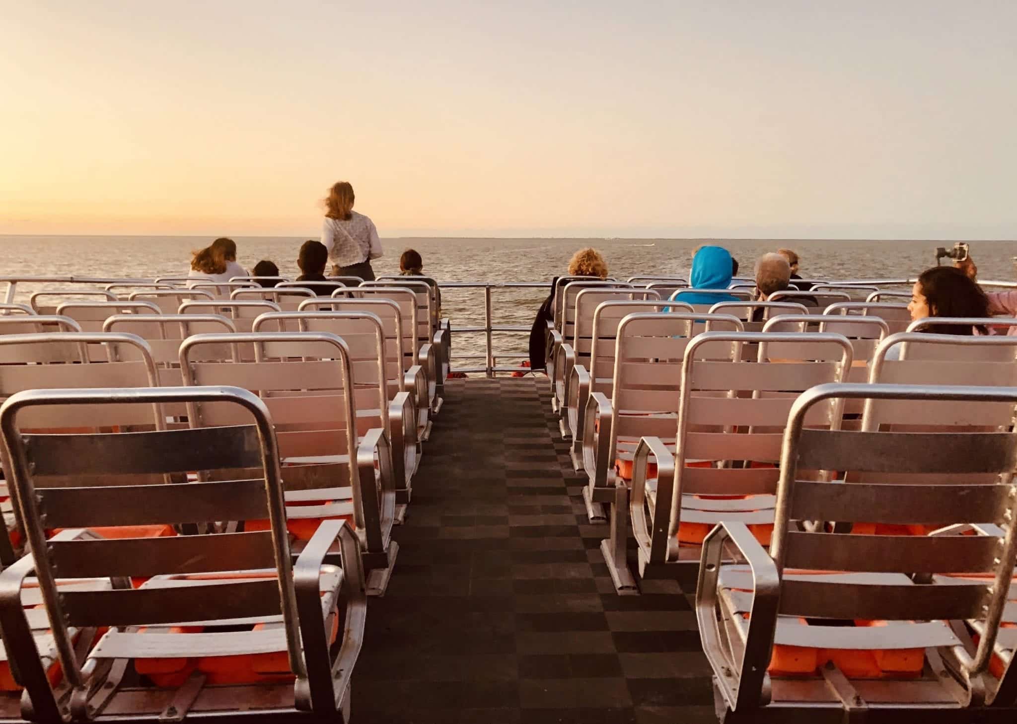 People sitting in chairs on a ferry.