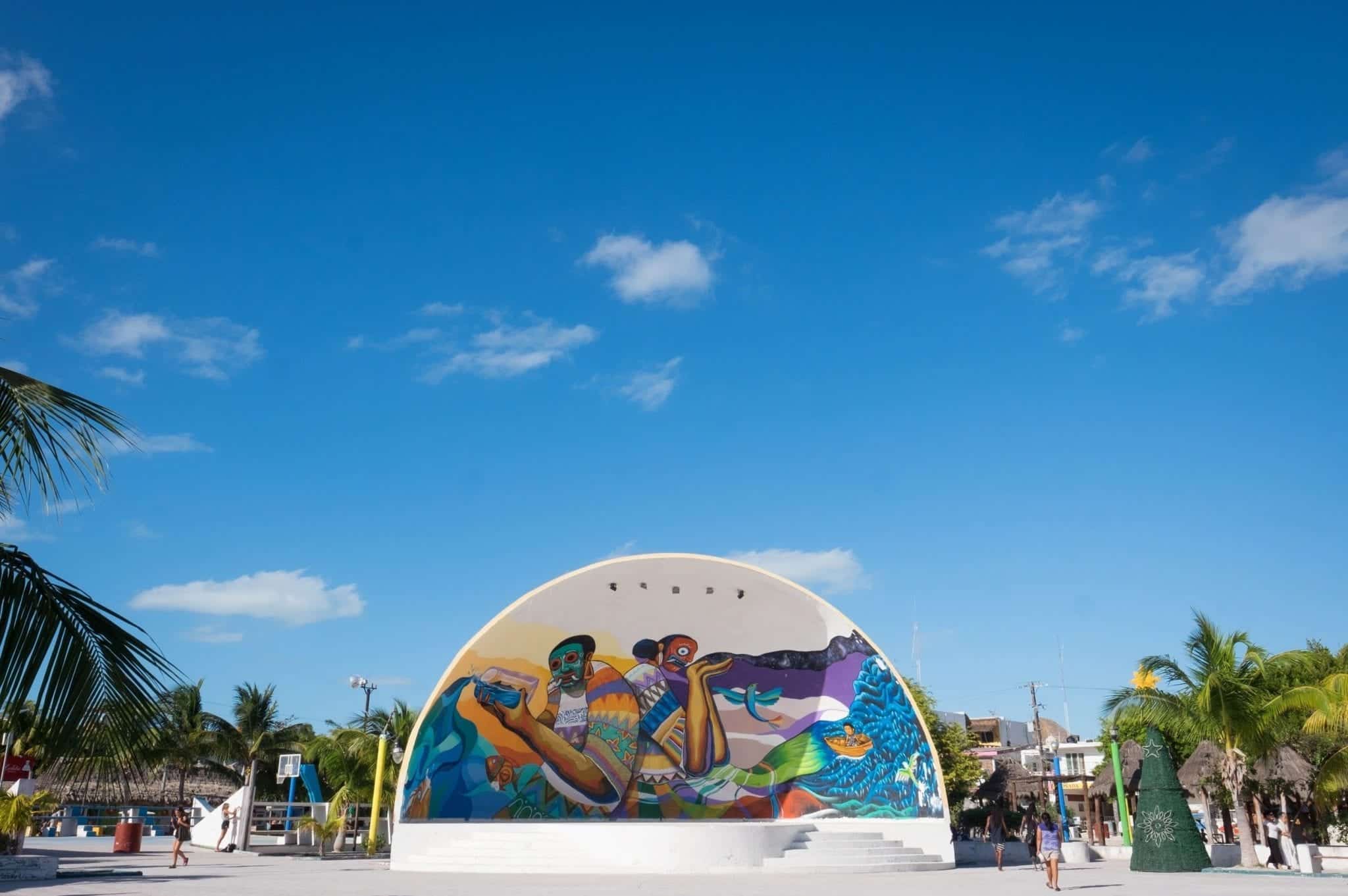A brightly painted amphitheater on Holbox Island against a bright blue sky.