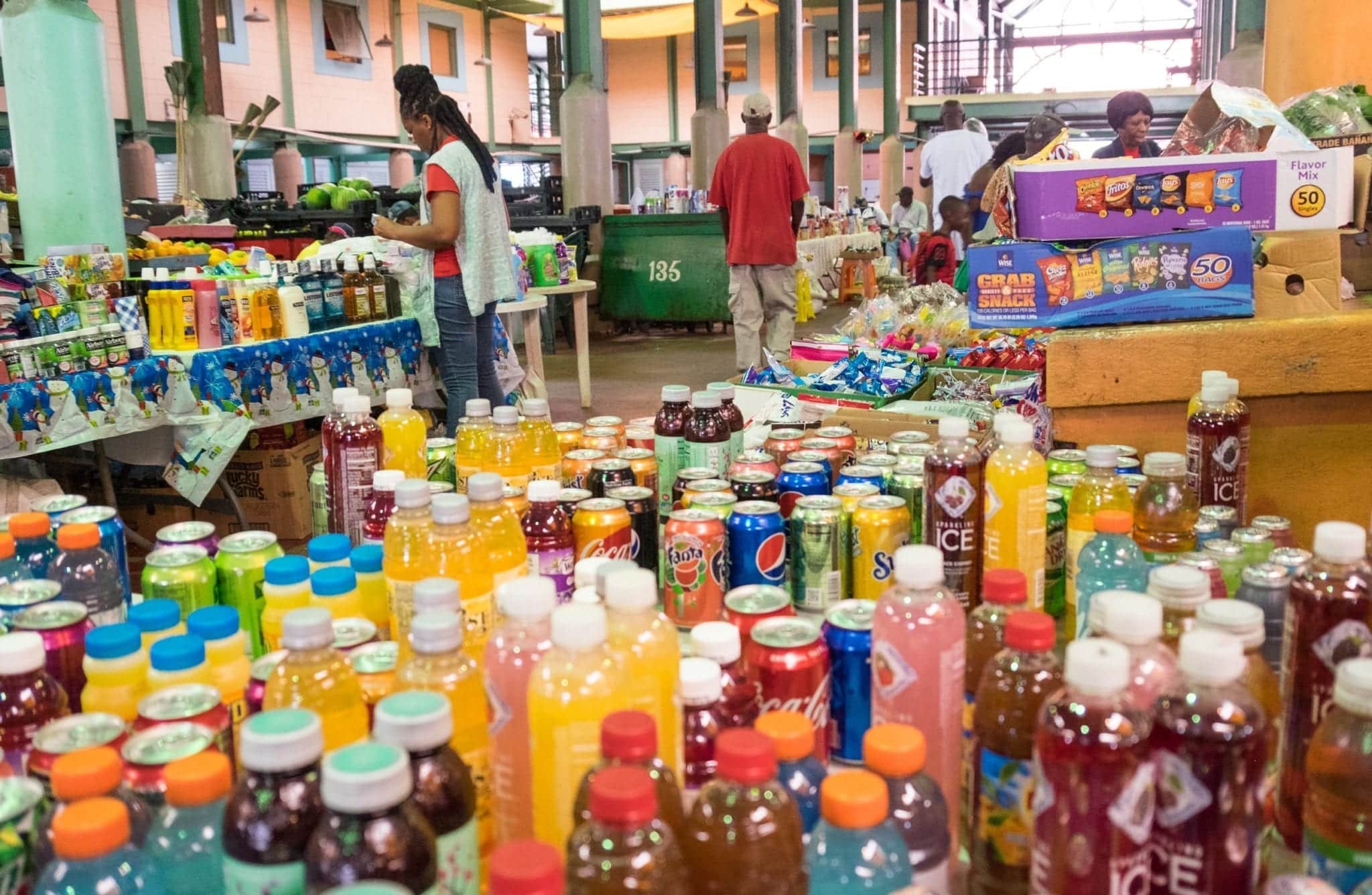 Dozens of bottled drinks on a table in a market in St. John's, Antigua