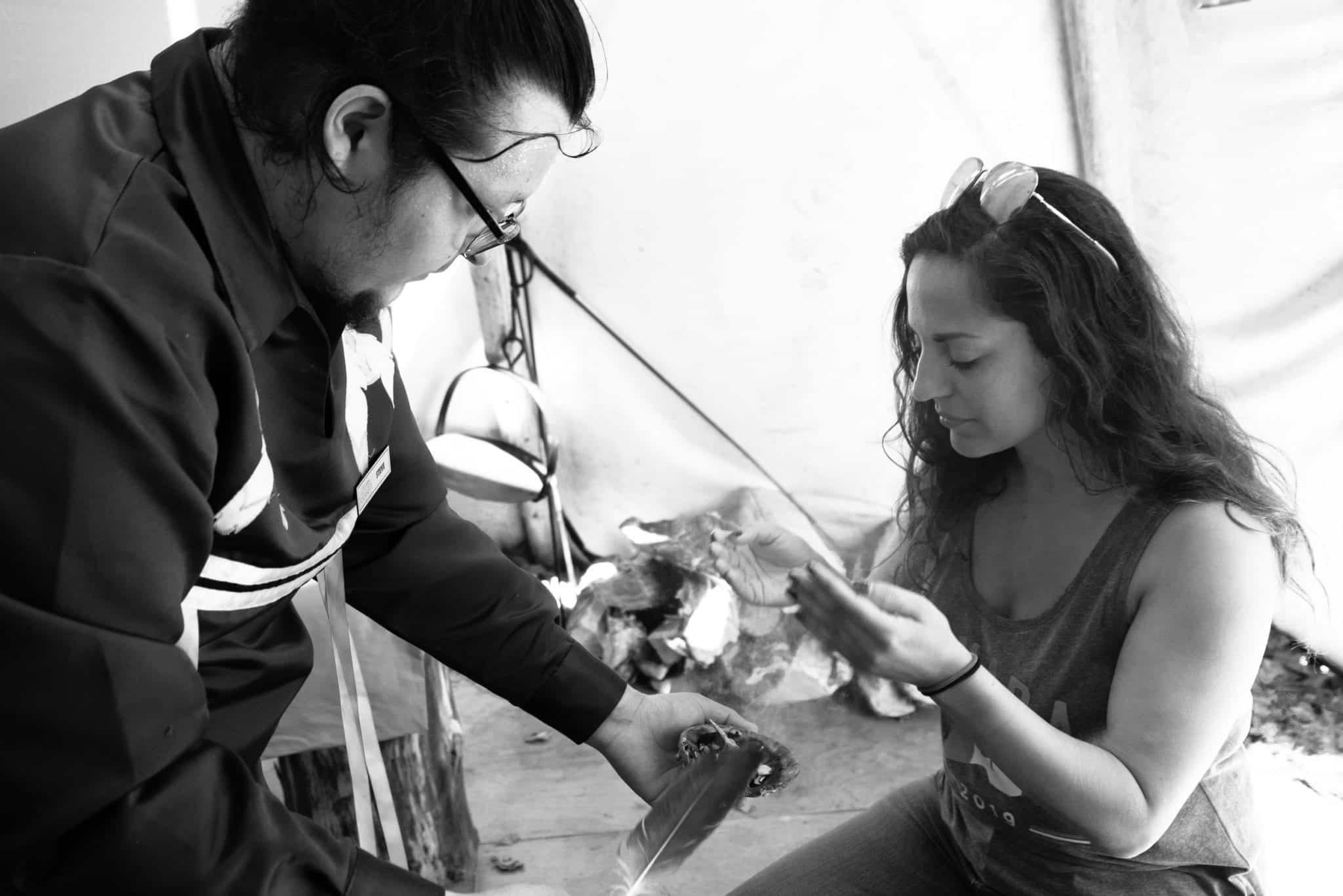 Kate gets smoke "smudged" on her in a Mi'kmaq ceremony with a local man.