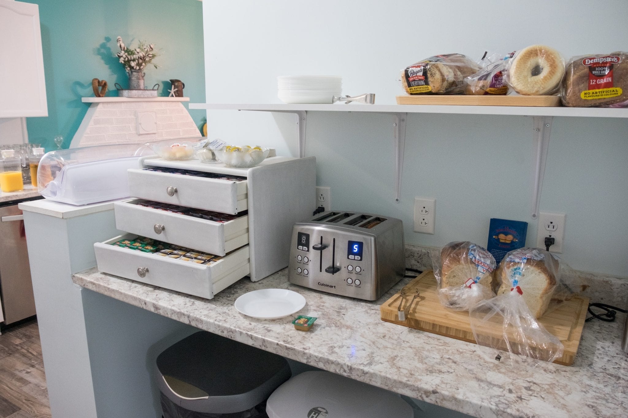 A counter with drawers filled with jams and several kinds of bread at Silver Linings Inn in Nova Scotia