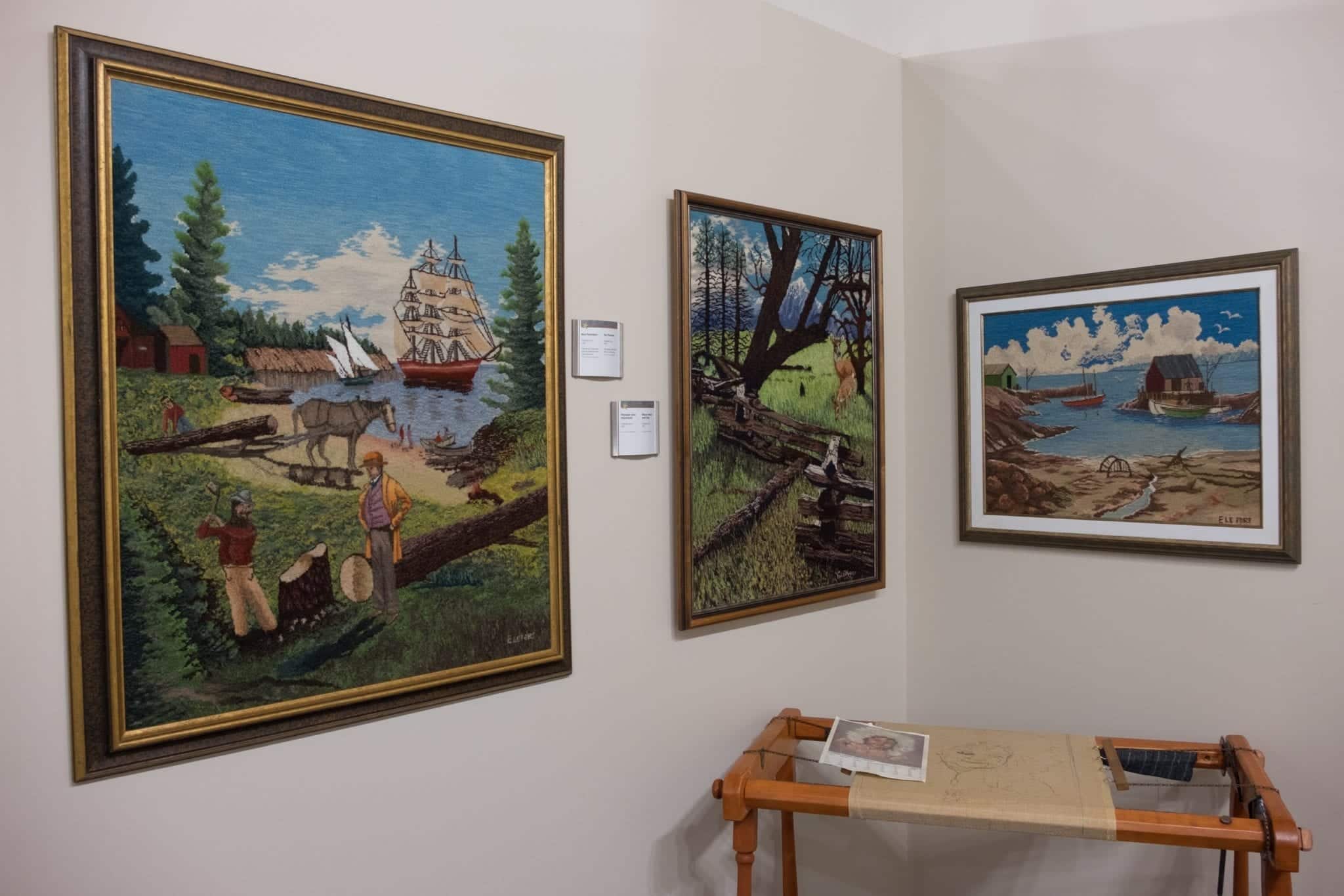 Three hooked rugs featuring Canadian landscapes.