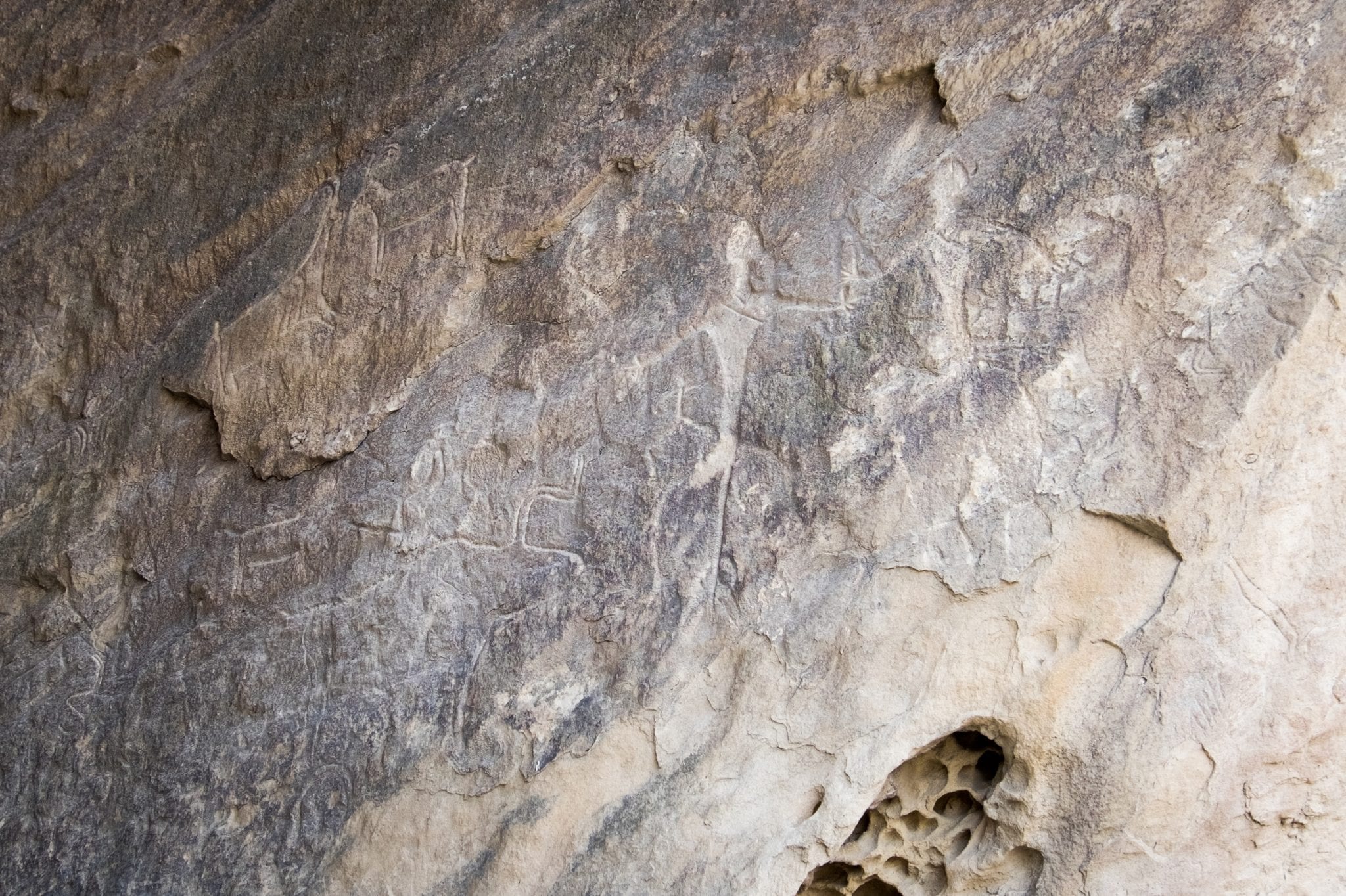 A petroglyph of two people hunting.