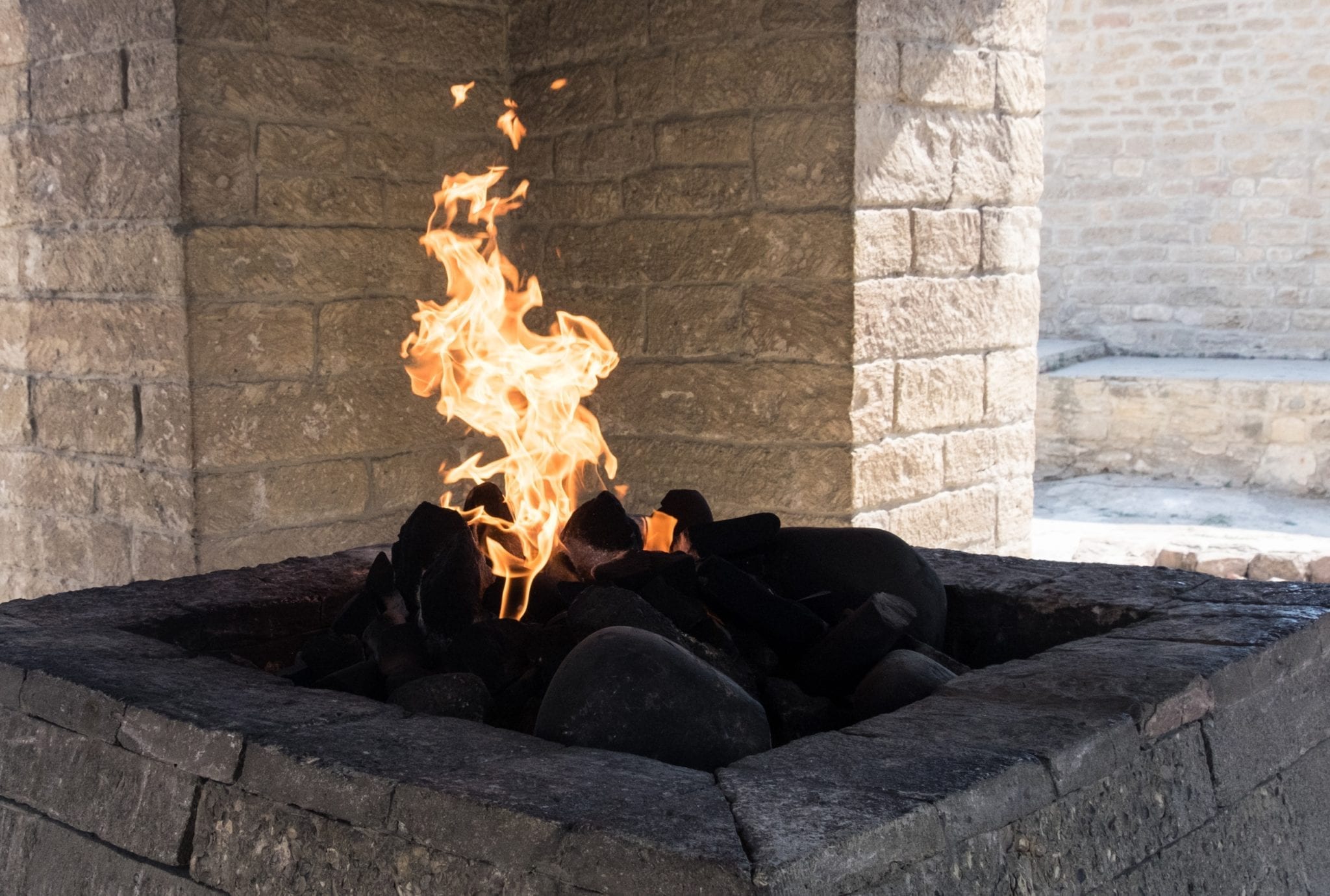 A fire burning inside Ateshgah temple, flames leaping up.