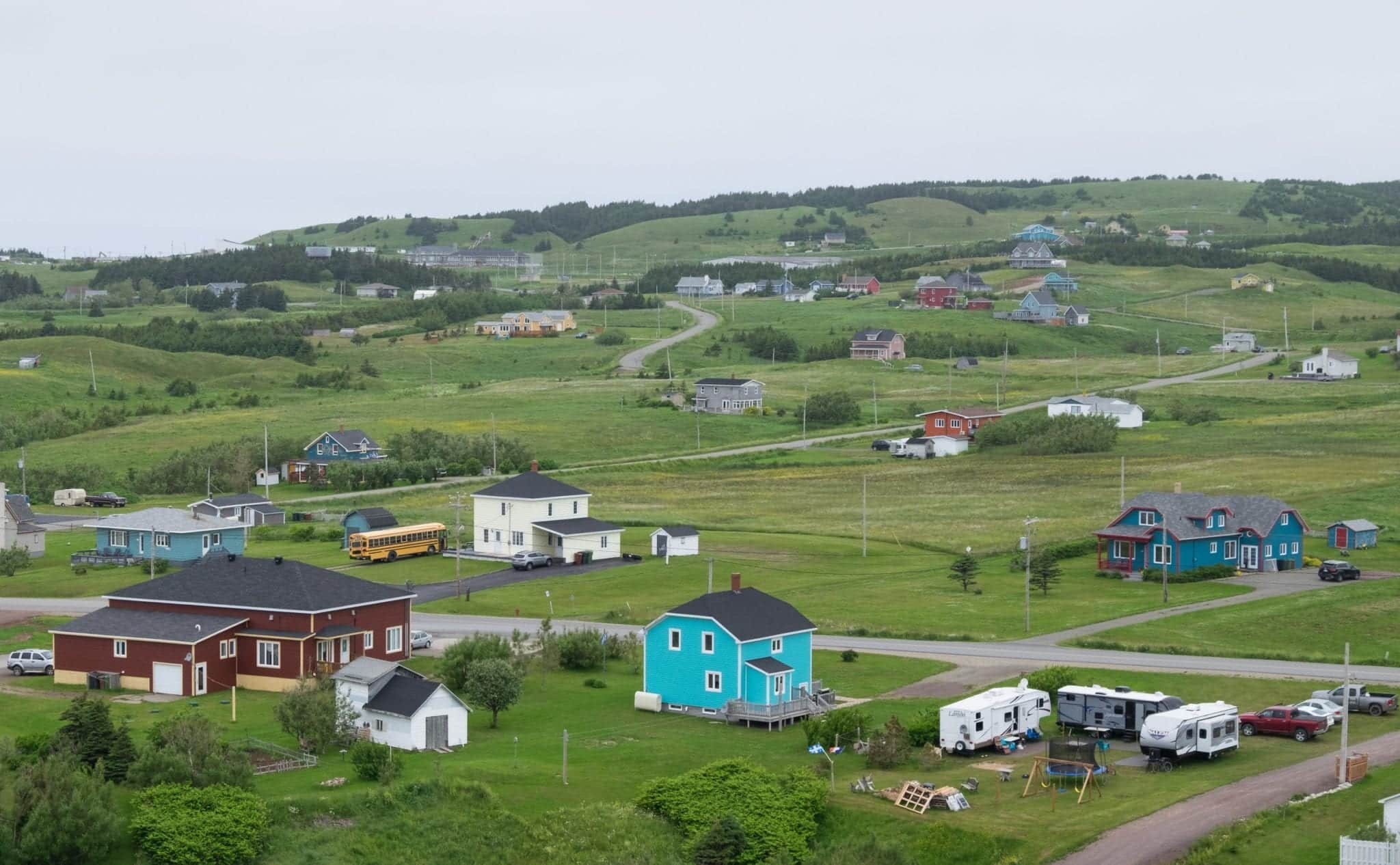 Tiny, brightly colored houses nestled into the hills of the Iles-de-la-Madeleine