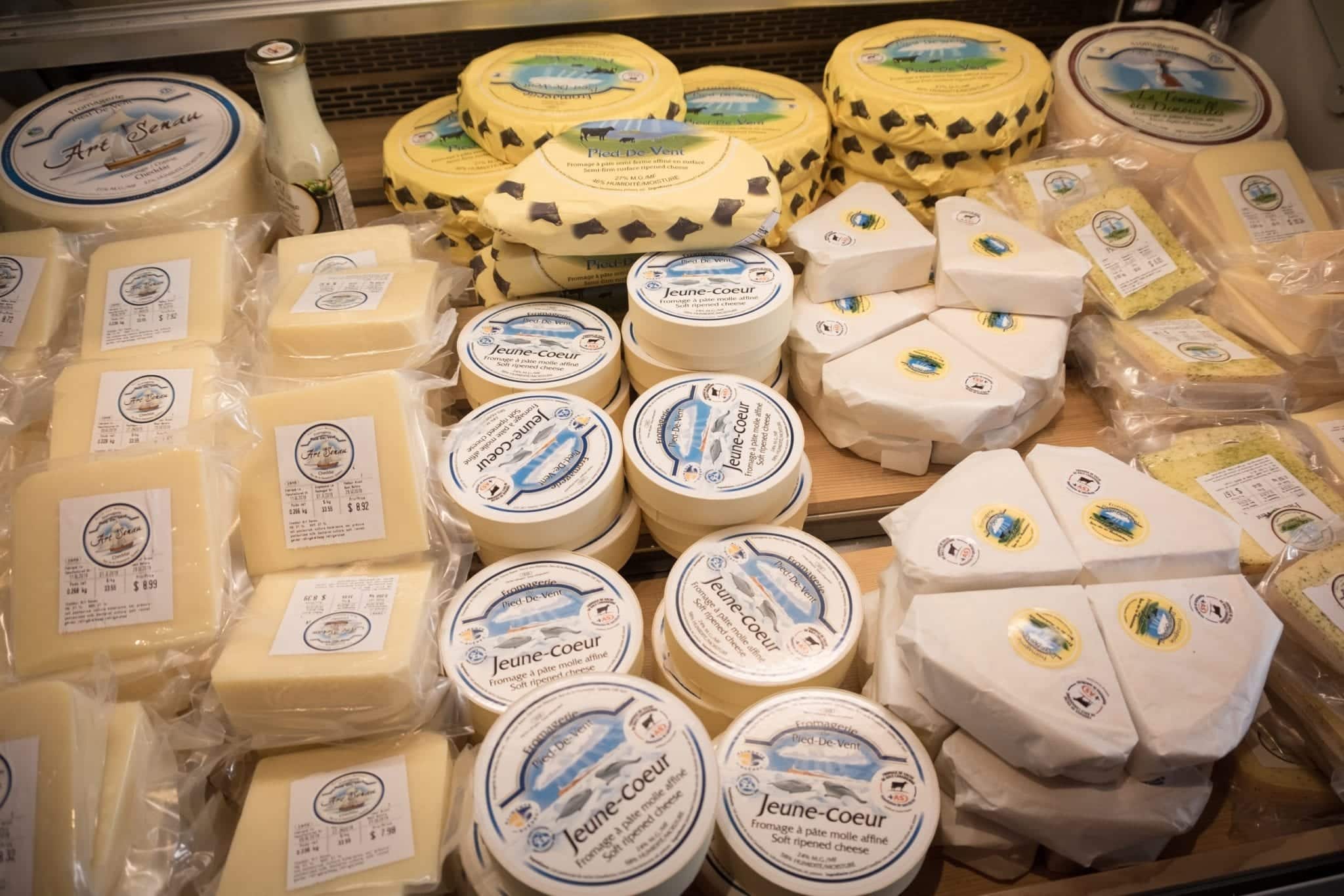 Piles of wrapped cheeses in a refrigerated container at Pied de Vent fromagerie in the Iles-de-la-Madeleine.