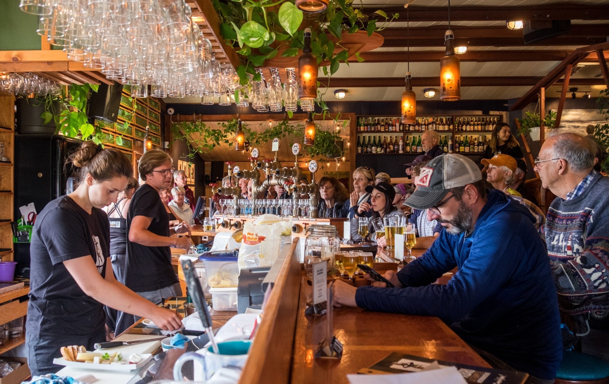 Bartenders serve beer to patrons at L'abri de la Tempete brewery in the Iles-de-la-Madeleine.