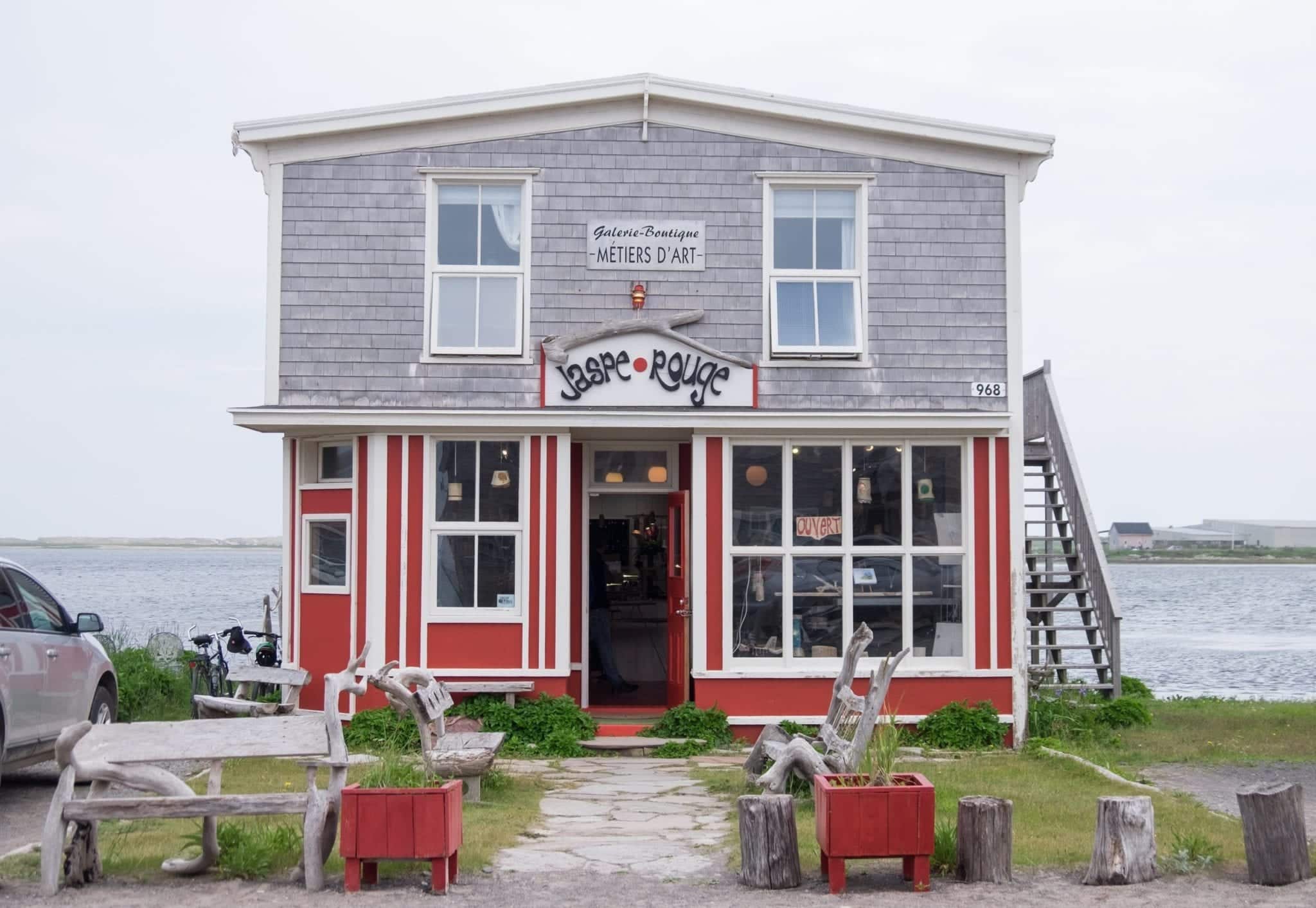 A gray house with a bright red bottom in La Grave.