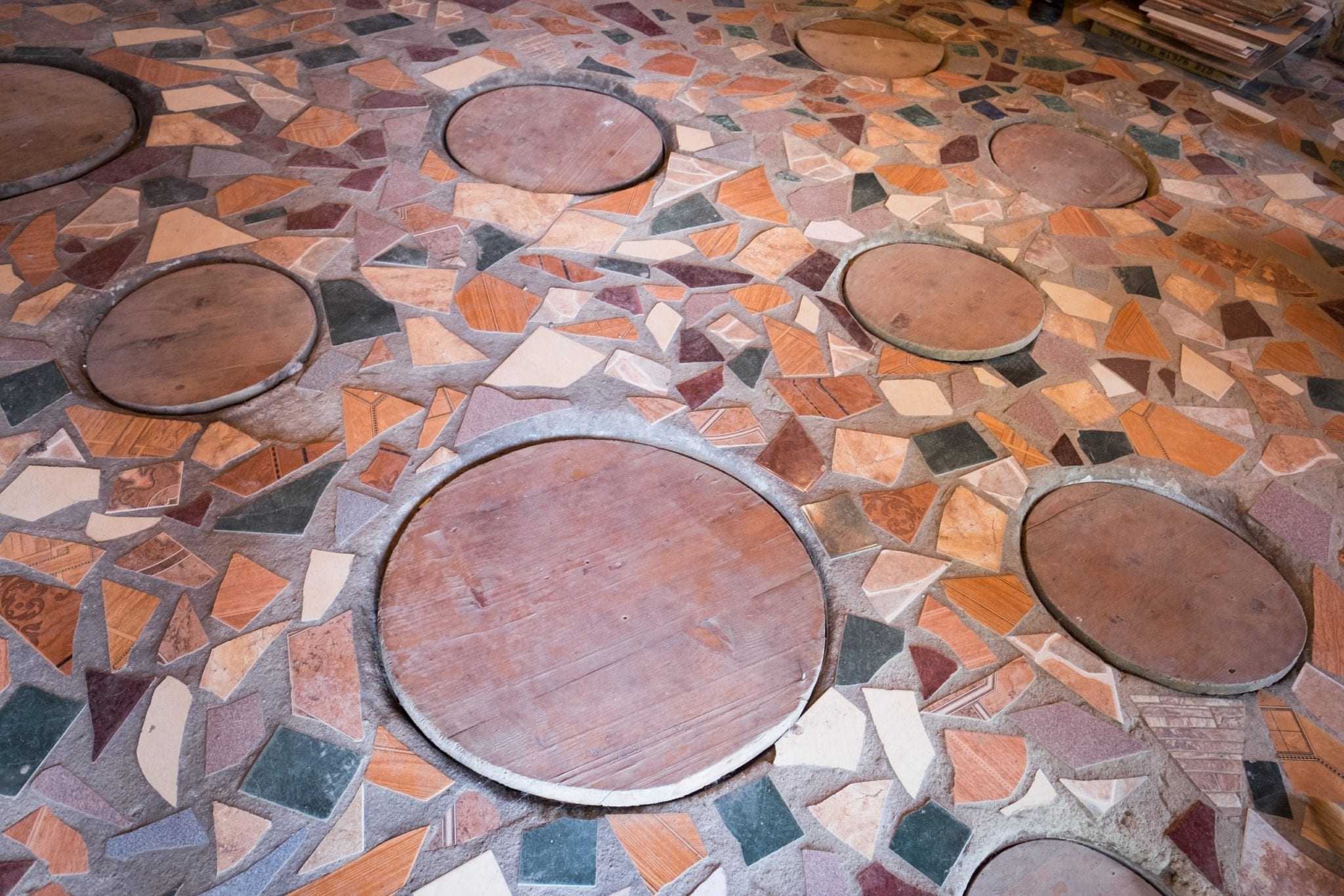 Round holes in a tiled floor where the Georgian qvevri wine is fermented.